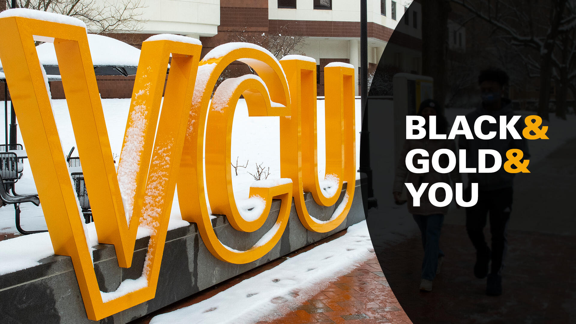 A sign made of giant letter that spell \"V C U\" in the snow. Next to it is a black half circle with the text \"BLACK & GOLD & YOU\". 