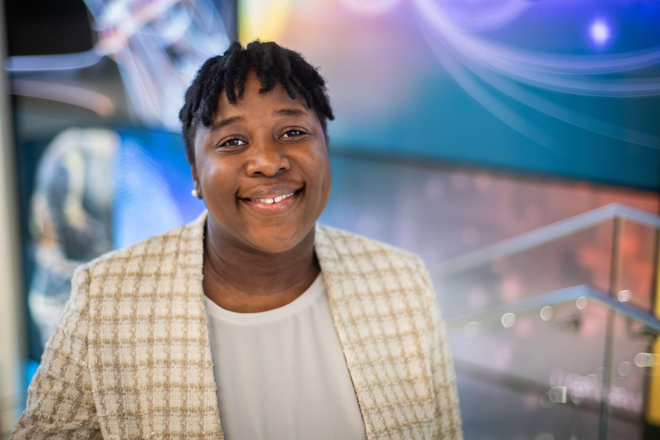 A photo of a woman smiling from the shoulders up. 