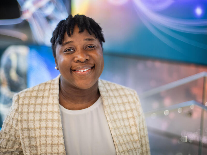 A photo of a woman smiling from the shoulders up. 