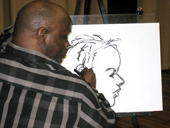 Joseph Norman drawing a student's portrait