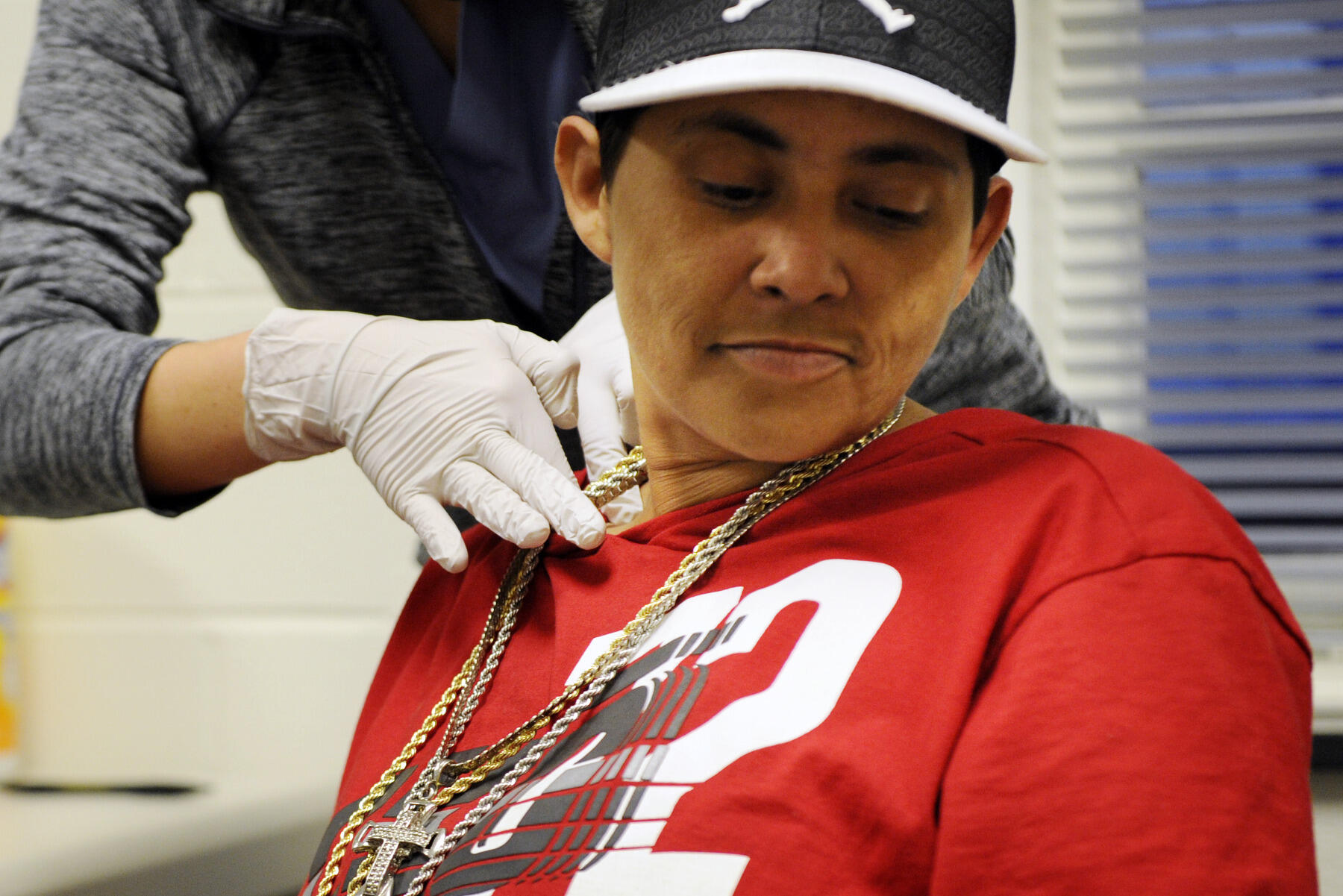 Tina Locklear has her lymph nodes checked during an oral health screening at the CARITAS clinic.
