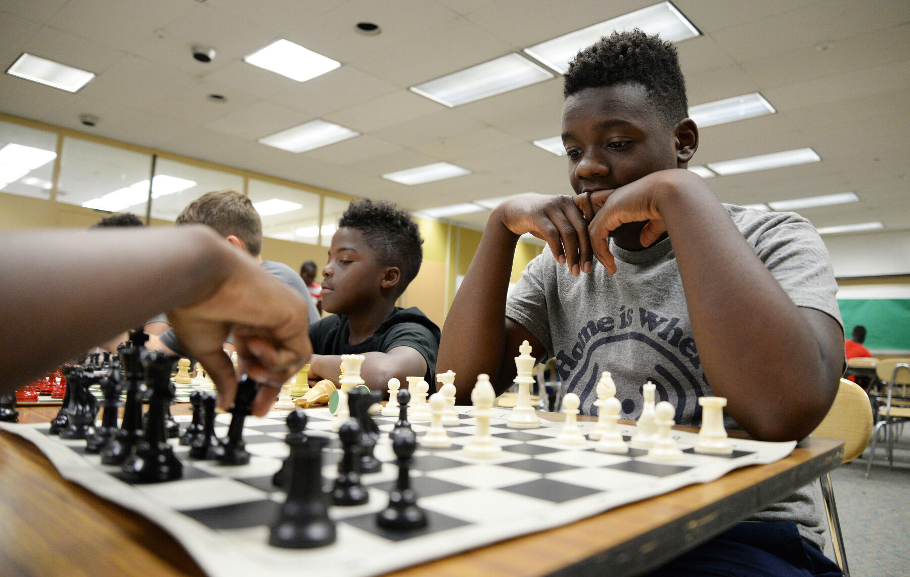 Luke Dove, 14, plays Caleb Penn, 12, at Legacy Chess Academy's chess program at Henderson Middle School.
