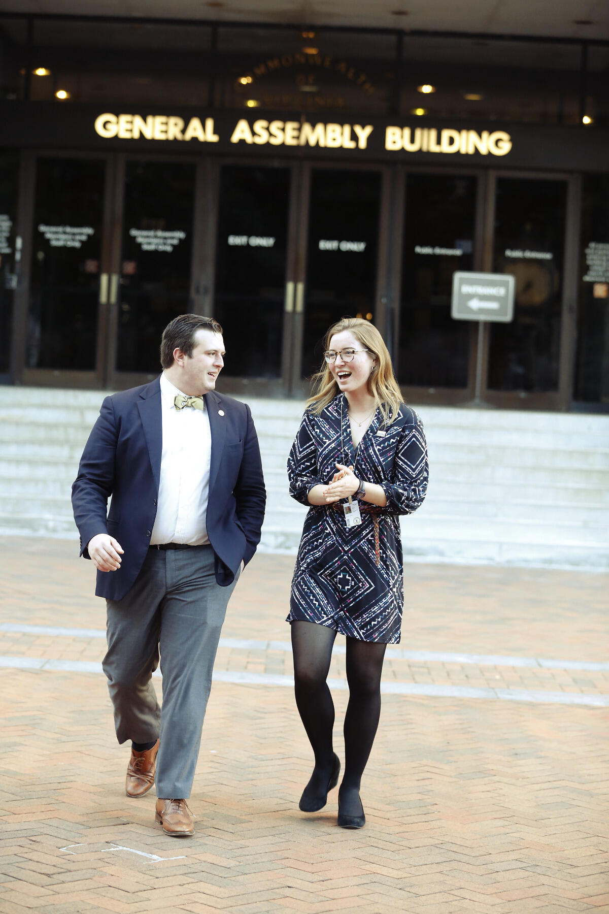 Brian Bailey and Julia Carney catch up on legislative business as they leave the General Assembly Building.
