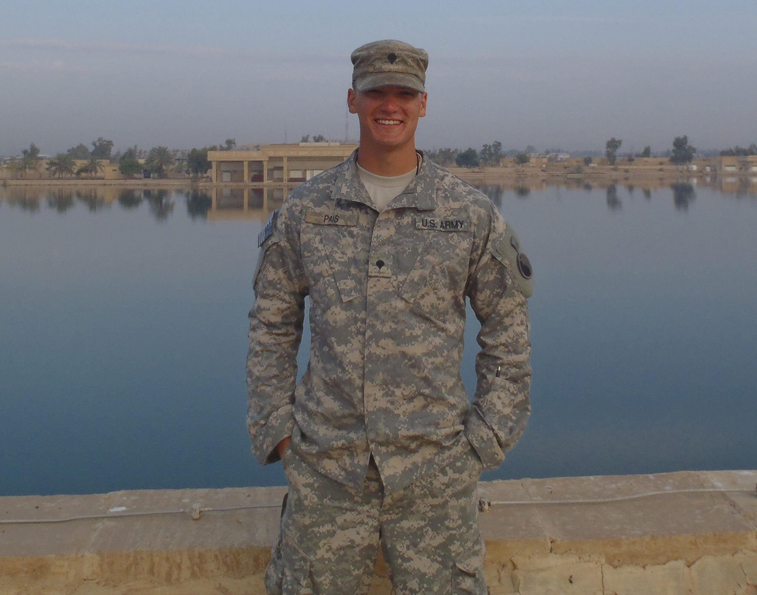 Chris in military uniform in front of a palace in Iraq.