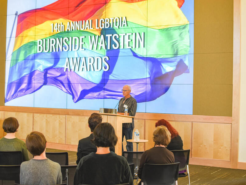 A person speaking in front of an audience. 