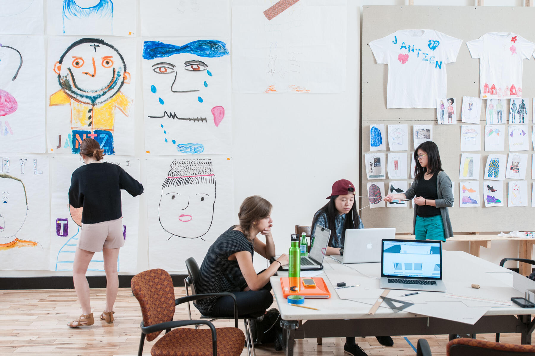 Miranda Leung (second from right) works on design concepts for a mOb+Storefront client project.
<br>Photo by Terry Brown Photography.