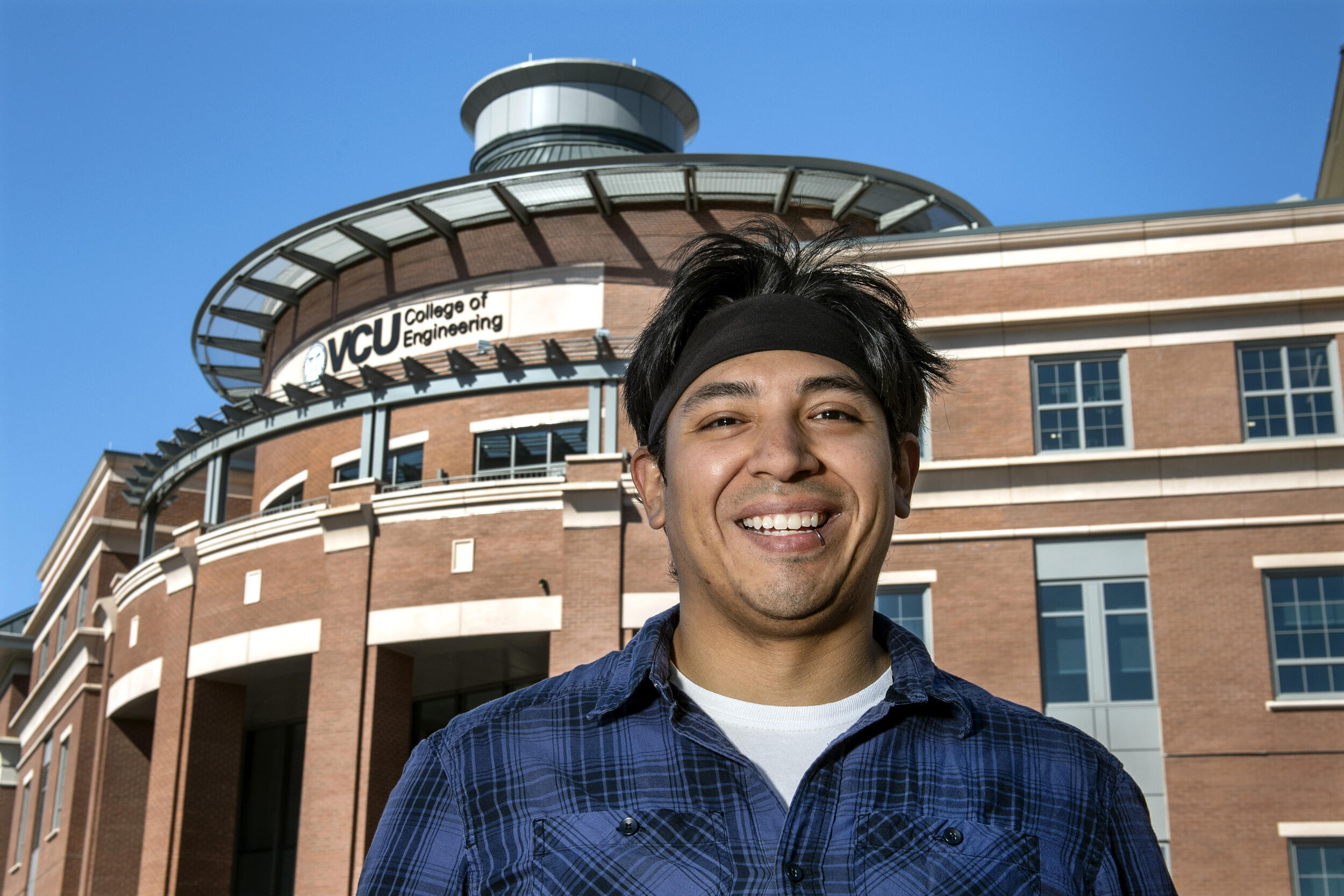 Jesus Guerrero standing in front of the VCU College of Engineering building 