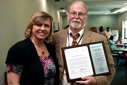 Dace Svikis, Ph.D., VCU AWARE program director, presents a plaque to Ned Snead, director of the Chesterfield Community Services Board Substance Abuse Division. Snead and program staff were honored for their commitment to improving outcomes for substance use patients in the surrounding area by integrating evidence-based practices into ‘real life’ drug abuse treatment.