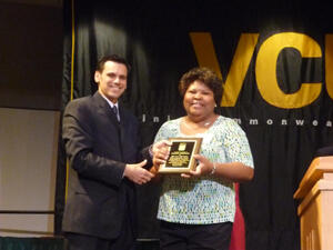 Photo- Pride Ambassador Award Ceremony- Maxine Robinson: Maxine Robinson of the Department of Surgery accepts her award from VCU President Michael Rao.