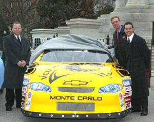 From left: B.J. Burton, associate athletic director for marketing and promotions at VCU, Gov. Mark Warner and Hermie Sadler unveil VCU's Winston Car Cup during a ceremony at the State Capitol.

Photo by Steve Rose, MotorSports Memories