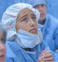 Tegan Chapman, a rising eighth grader at Richmond's Collegiate School pays special attention to one of the instructors in the operating room. Before entering the O.R., the students were asked to wear surgical gowns and masks.