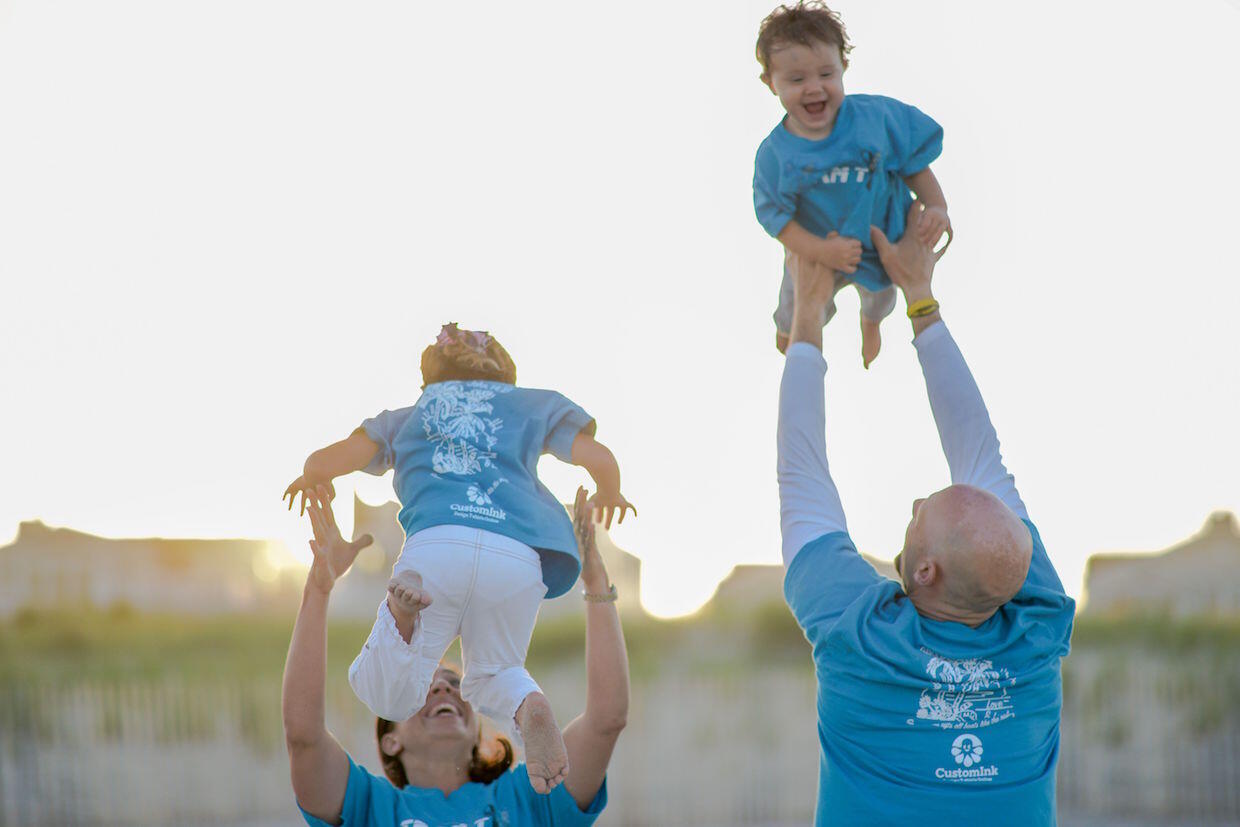 Cancer survivor and clinical trial advocate T.J. Sharpe, bottom right, playing with his children.