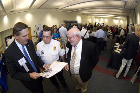 Conference attendees met with vendors who demonstrated the latest products and services to improve campus security. VCU Police Capt. Grant Warren (center) talks with AlliedBarton Security Services representatives Chris Roberts (left) and Glenn Rosenberg. Photos by Melissa Gordon, VCU Communications and Public Relations.
