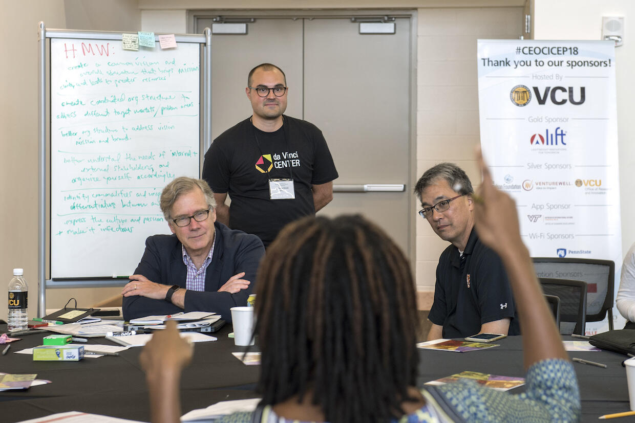 Andrew Ilnicki (standing), director of academic technology in the VCU School of the Arts, oversees the discussion of potential solutions to a pressing community challenge. (Photo by Kevin Morley, University Relations)