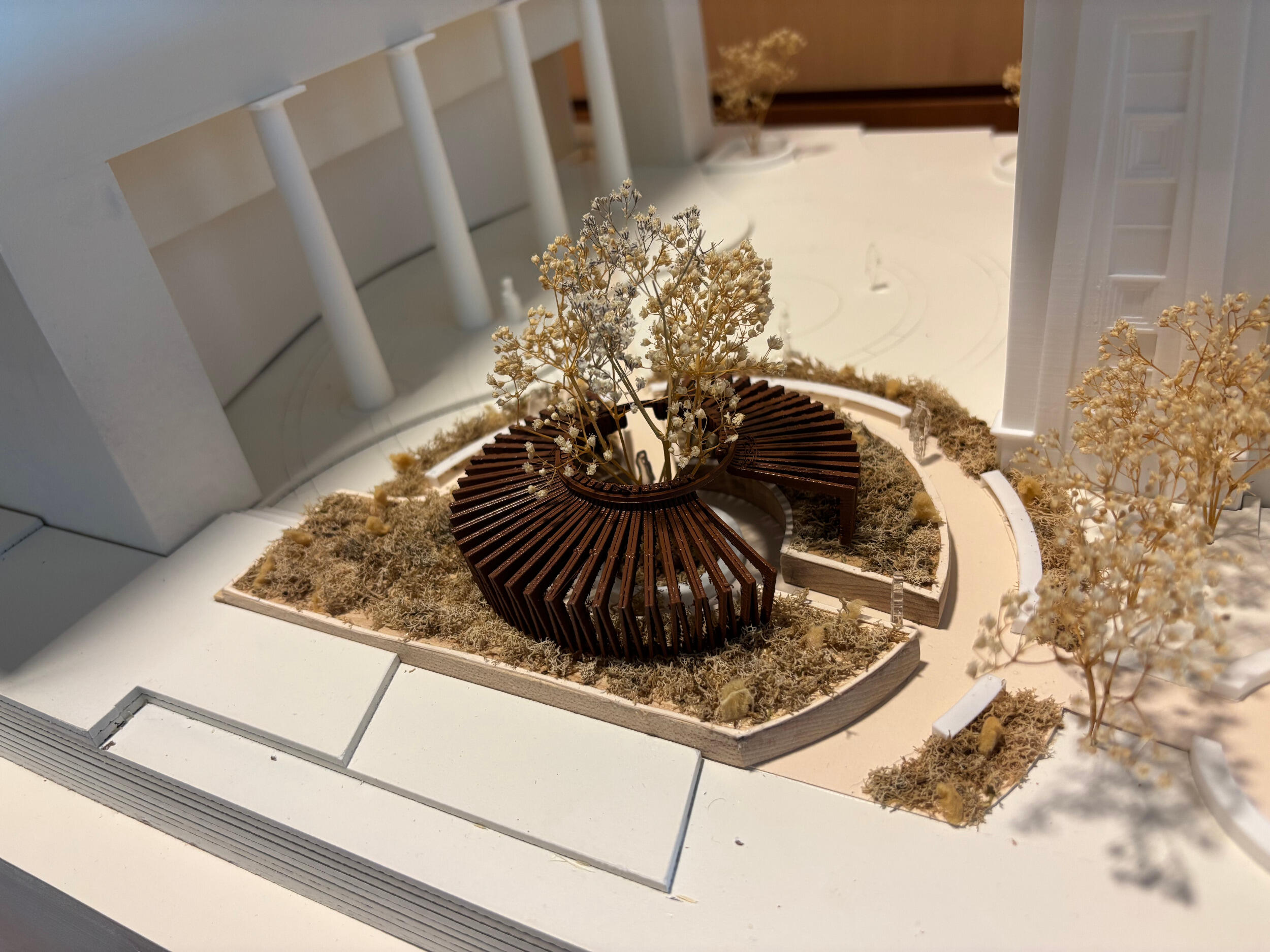 A model of a small building in a courtyard area.