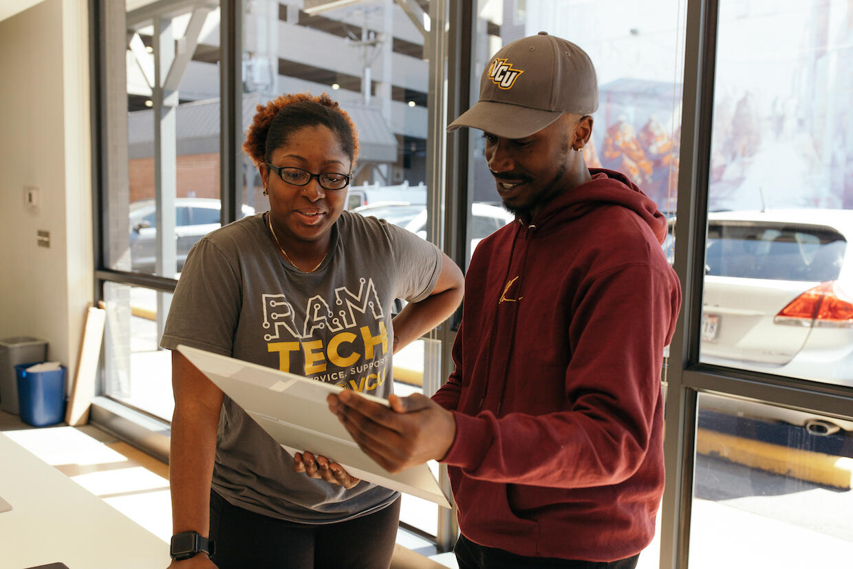 RamTech student employees Bryttan Chandler and Alistar Feury discuss the versatility of the new Google Pixelbook. (Photo courtesy of RamTech)