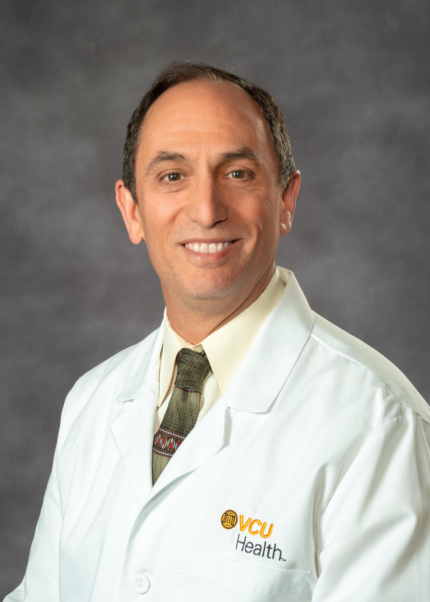 A photo of a man from the chest up. 