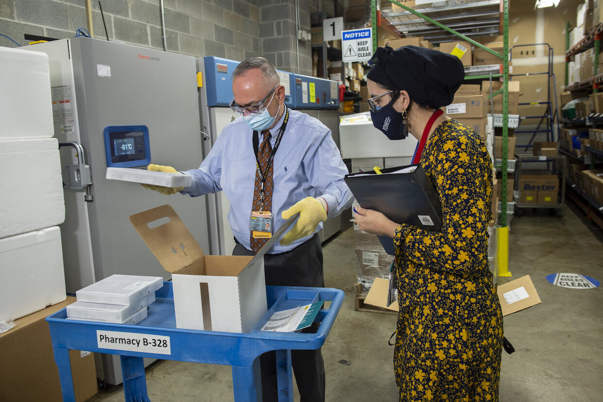 Rodney Stiltner and Sumayya Beekun inspect the contents of a box.