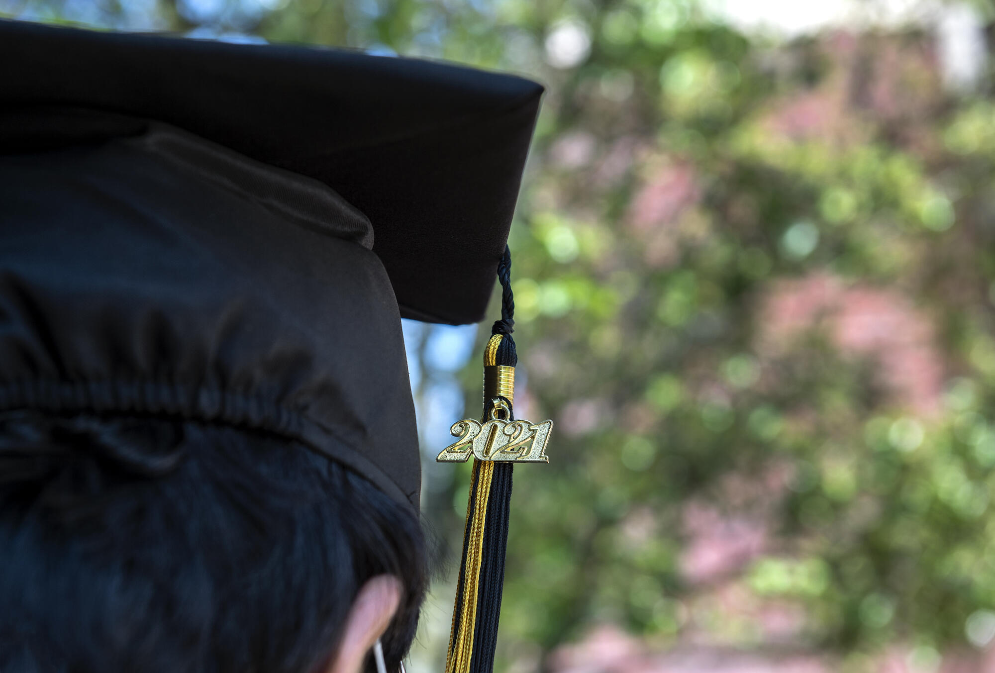 close-up photo of a person wearing a graduation cap