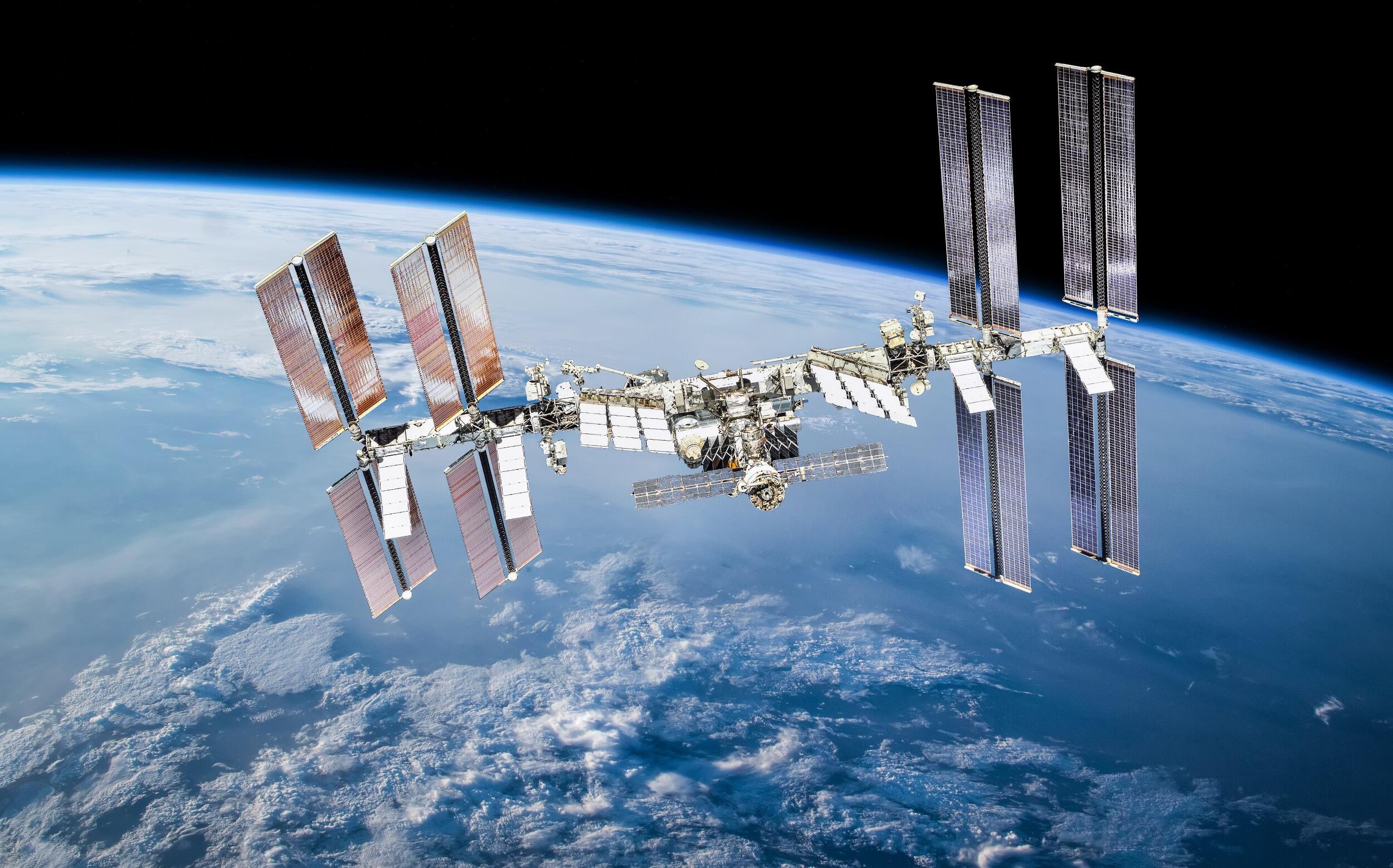 The international space station floating in space over the planet earth.