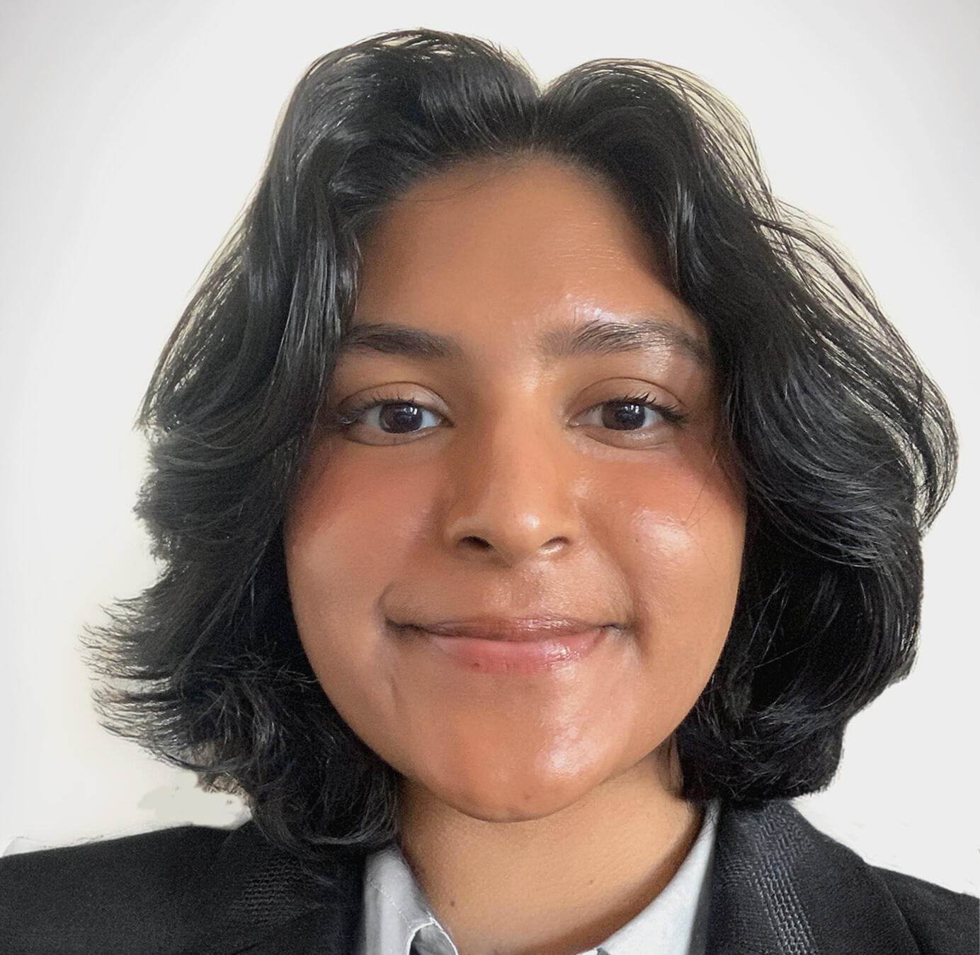 A photo of a woman from the shoulders up. 