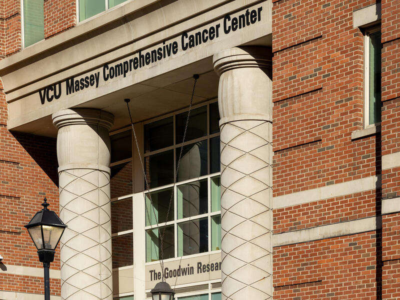 A photo of the front of a building. Above the archway to the door are black letters that spell out \"VCU Massey Comprehensive Cancer Center.\"