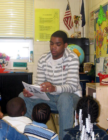A story of success:  VCU Carver Promise mentor Preston Simms reads to students at Carver Elementary School.  Male mentors are in great demand. Simms hopes his participation will make a difference as the children grow up. Photo by Mike Porter/ VCU Office of University News Services. 