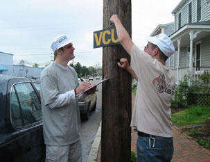 From left: Project leader Jeff Knighton, and Nick Stevens, both of VCU's Department of Political Science, post a VCU sign outside the Carver home they repaired.

Photo by Jennifer Curtis, University News Services