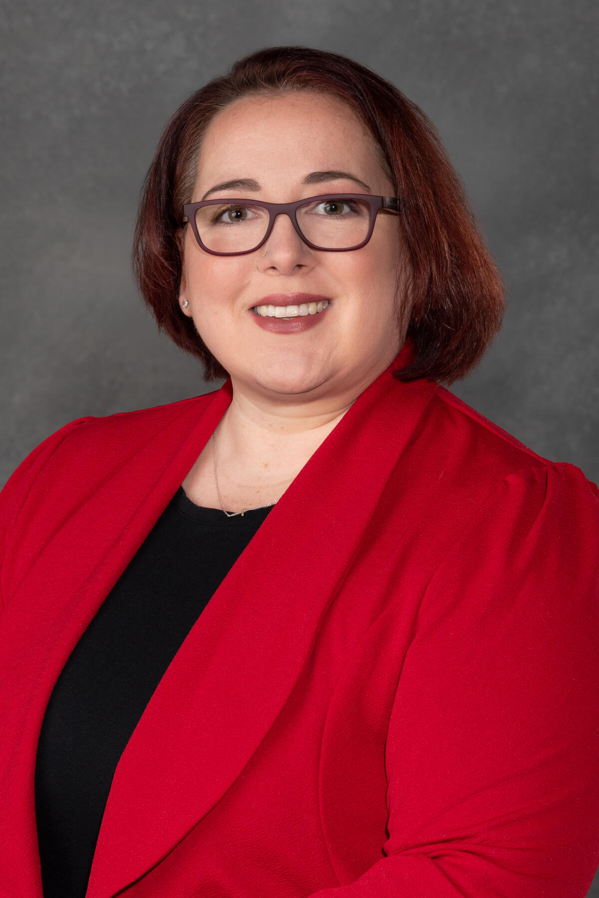 A photo of a woman from the chest up. 