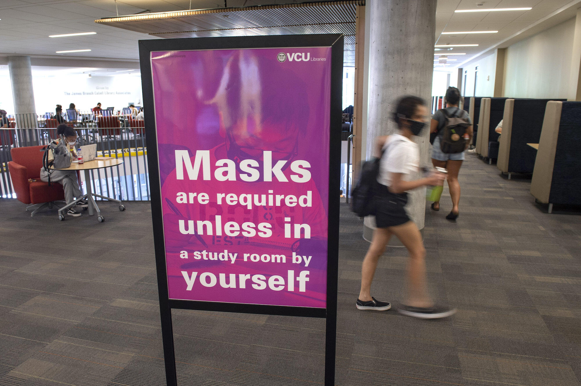Sign that reads \"masks are required unless in a study room by yourself\" inside James Branch Cabell Library.