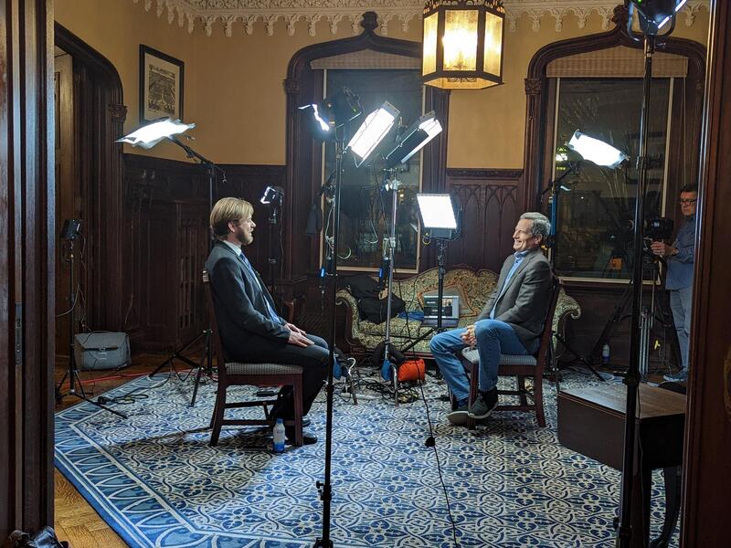 "CBS Sunday Morning" correspondent David Pogue (right) interviews Alex Keena, Ph.D., an assistant professor in the Department of Political Science, at Scott House on VCU's Monroe Park Campus. (Mary Kate Brogan, Enterprise Marketing and Communications)