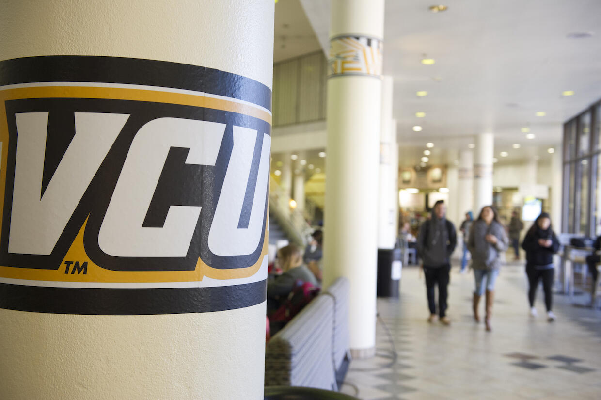 A V C U logo pictured on a column inside the University Student Commons building.