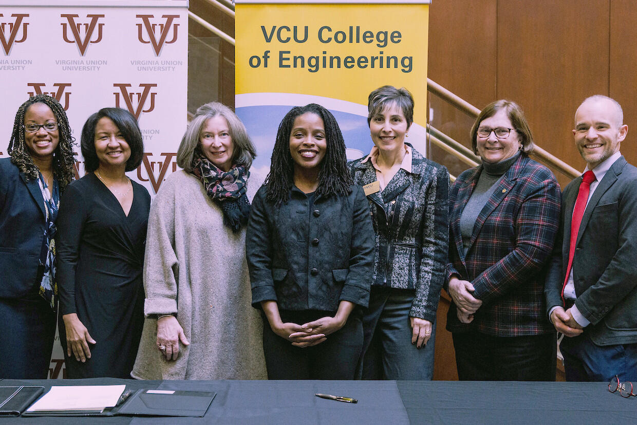 Seven people standing under banners reading "VUU" and "VCU College of Engineering"