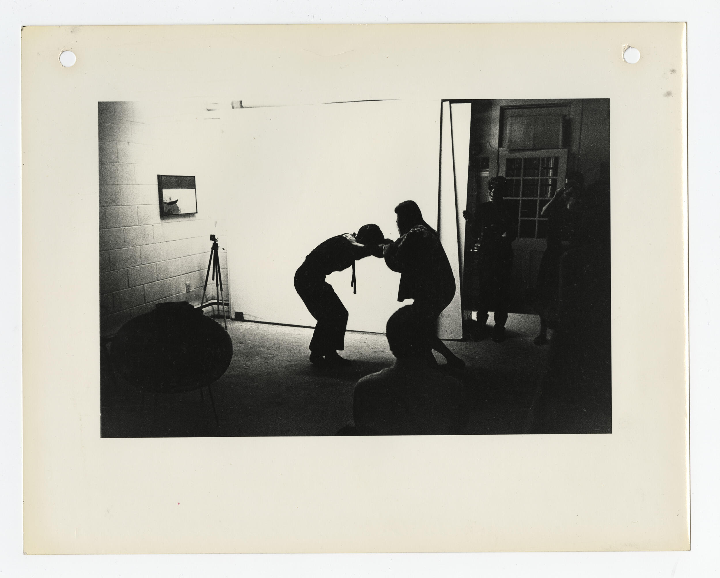 A man and a woman dancing in a dimly lit room.