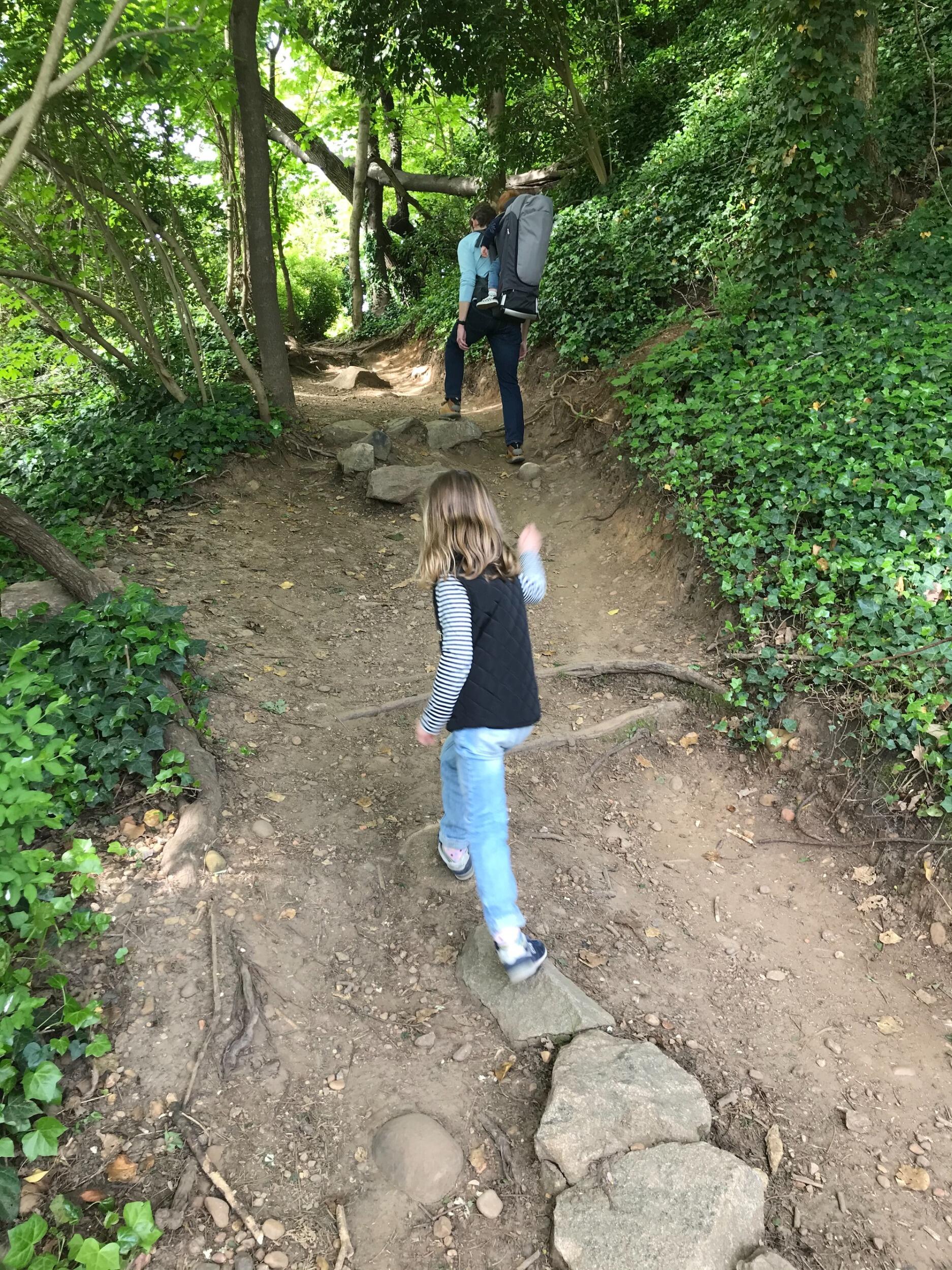 Child and mother walking on a trail