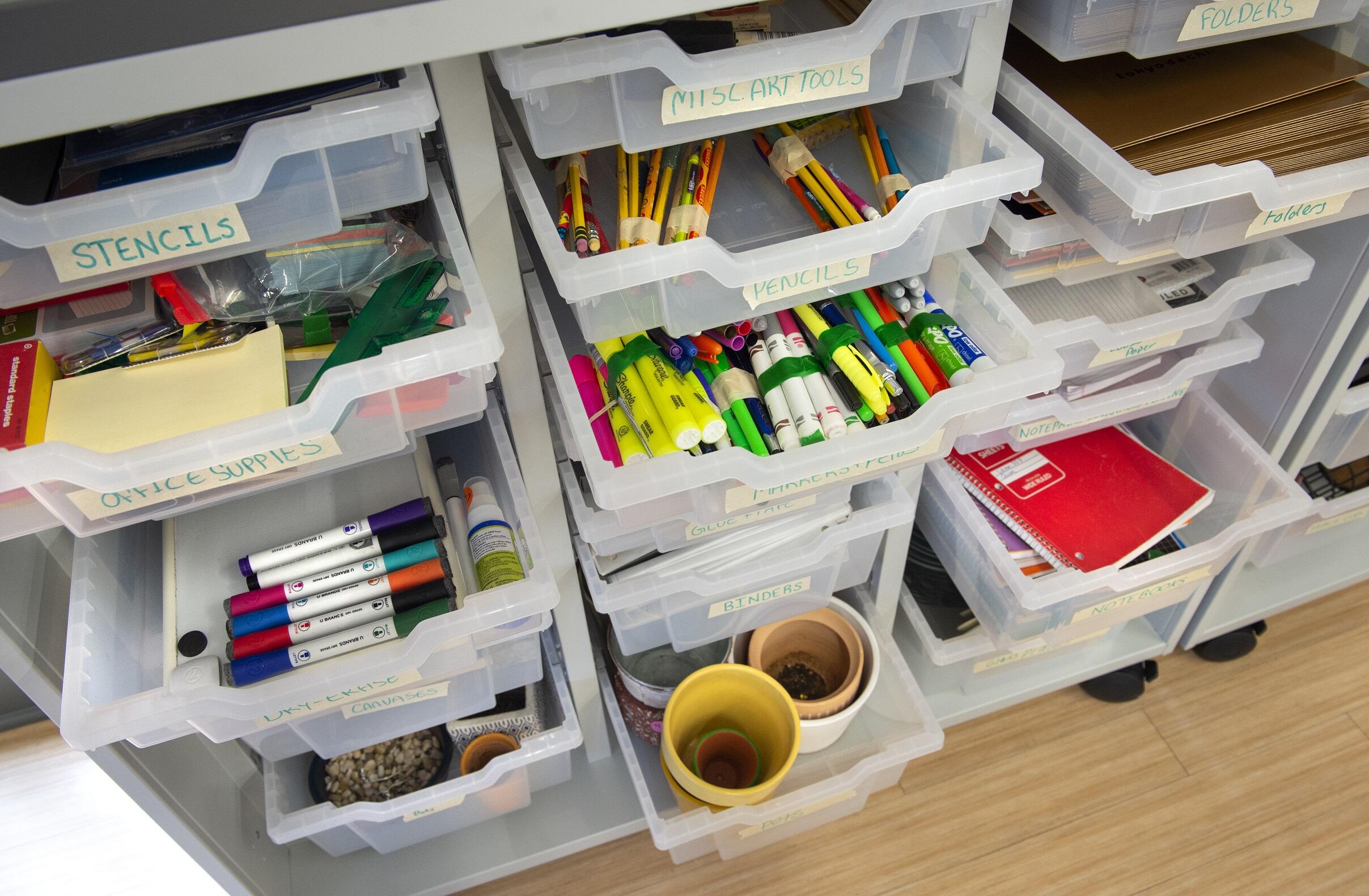 A photo of open drawers filled with school supplies. 