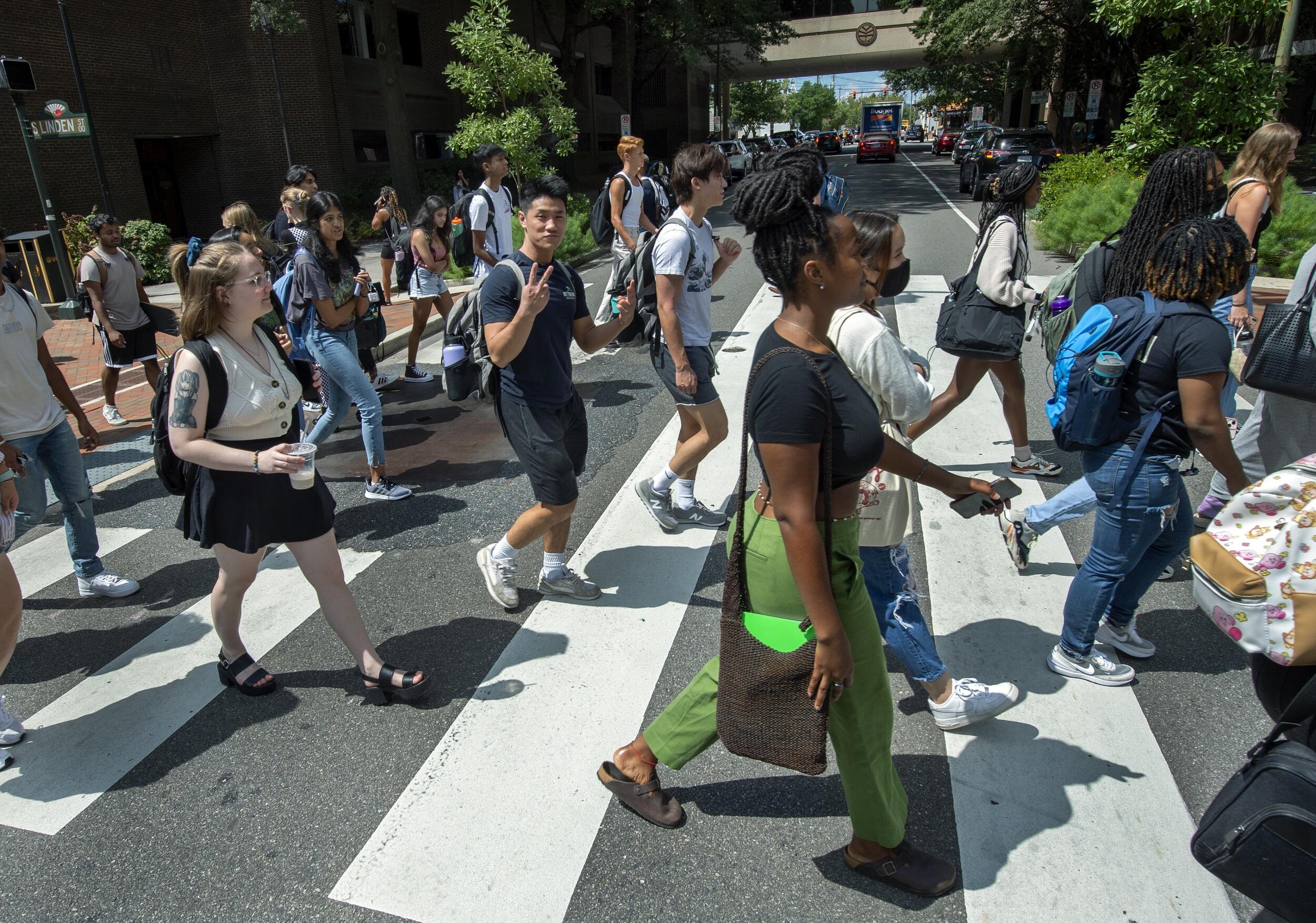 A group of students walking across a crosswalk. 