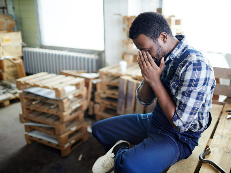 Black man at work and in pain