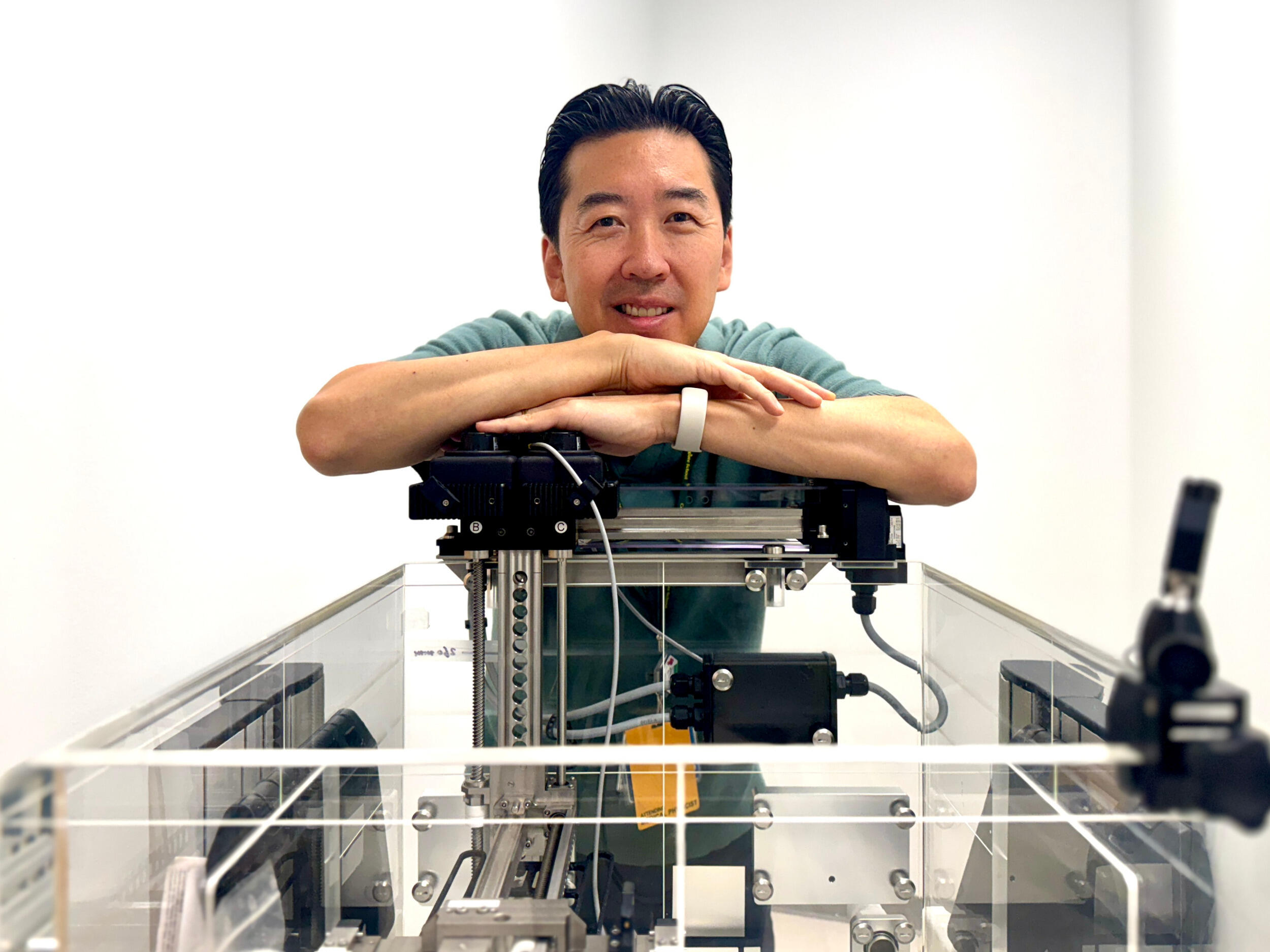 A man leans on a machine.