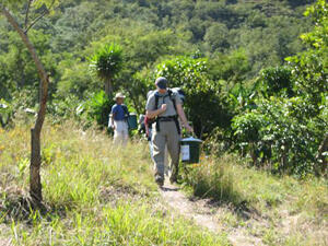 Nathan D. McLaughlin carries a water filter that he is about to deliver to a home.