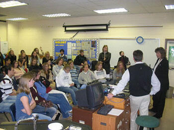 Brett Harnett, director of experimental information technology at VCU and Debbie Justis, RN, clinical coordinator of telemedicine, talk telemedicine with students in the Math and Science High School at Clover Hill.