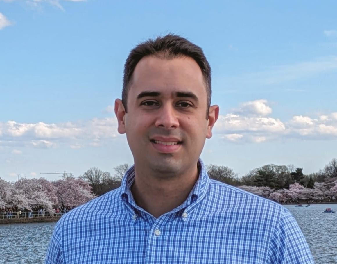 A photo of a man from the shoulders up. 
