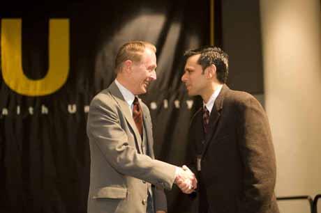 VCU President Michael Rao, Ph.D., (right) thanks Larry Robinson of the School of the Arts for his 50 years of service to the university at the 38th service award reception on the Monroe Park Campus. Photo by Thomas Kojcsich.