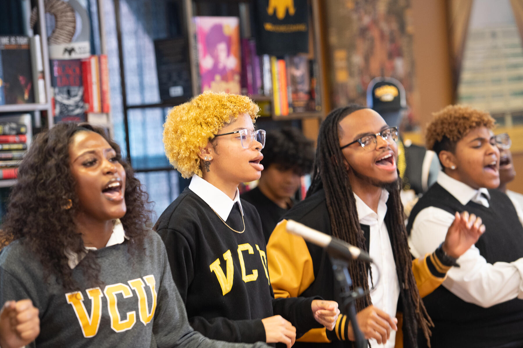 Members of the Black Awakening Choir sing at a microphone.