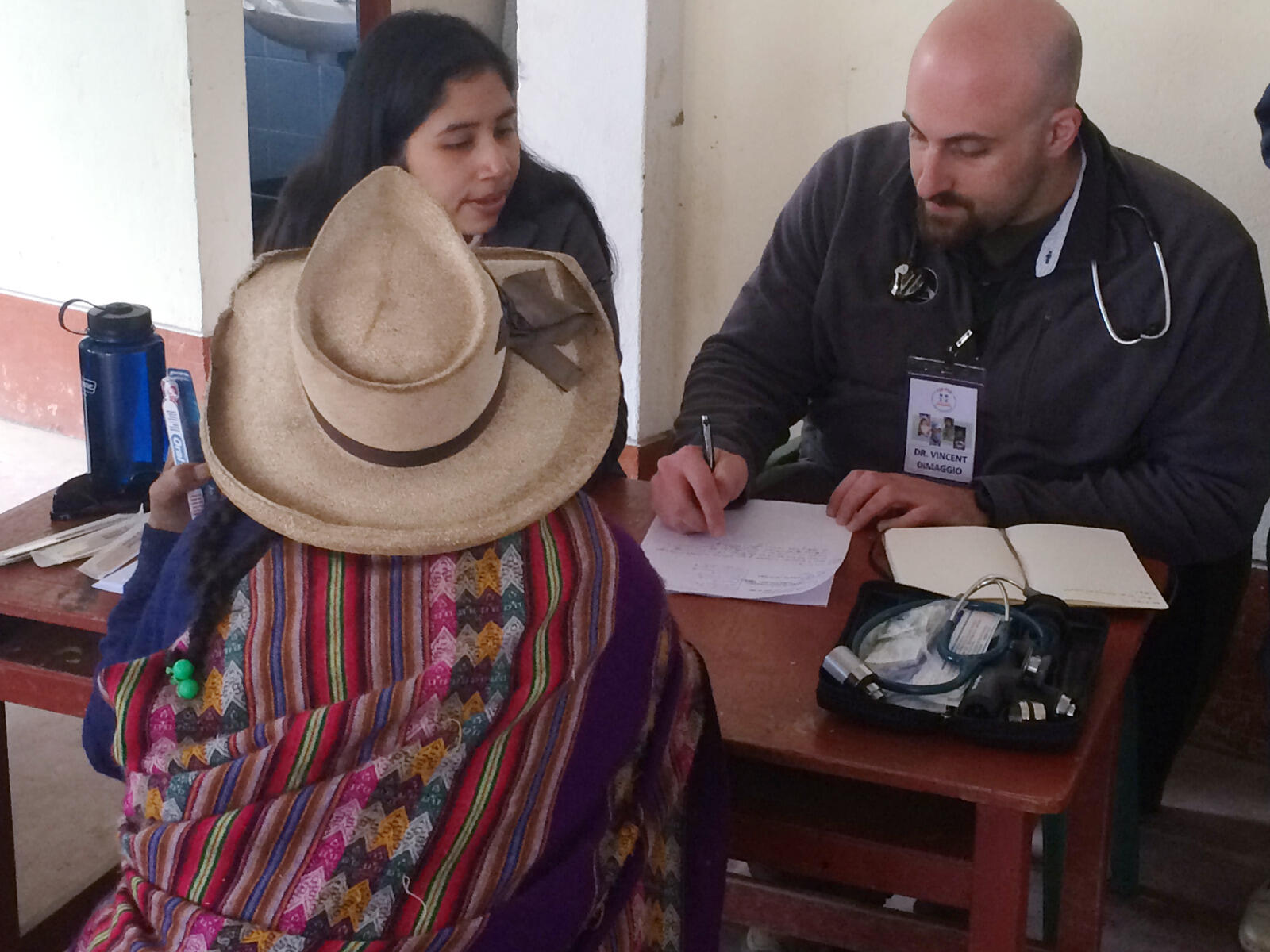 Karina Espinoza, left, a student in the VCU School of Medicine, assists with taking patient notes. Espinoza's mother lived in Pampas Grande until she moved to Lima at age six. Some of Espinoza's extended relatives are patients at the RGHA clinic and her grandfather was mayor of the district. 'I love going to Pampas [Grande] as I am able to serve my mother's hometown and extended family members,' Espinoza said. Pictured right: Vincent DiMaggio, M.D., clinical associate of pediatrics at the University of Chicago.
<br>Contributed photo by RGHA