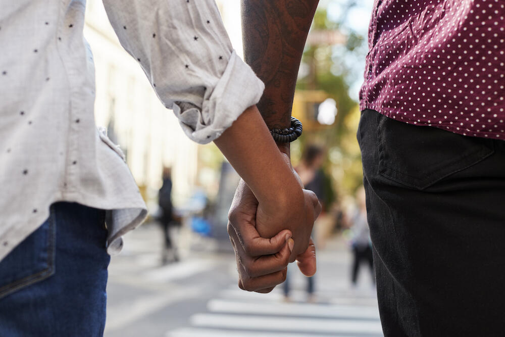 Couple holding hands while walking