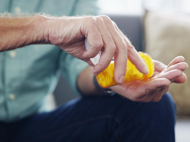man pouring pills into his hand