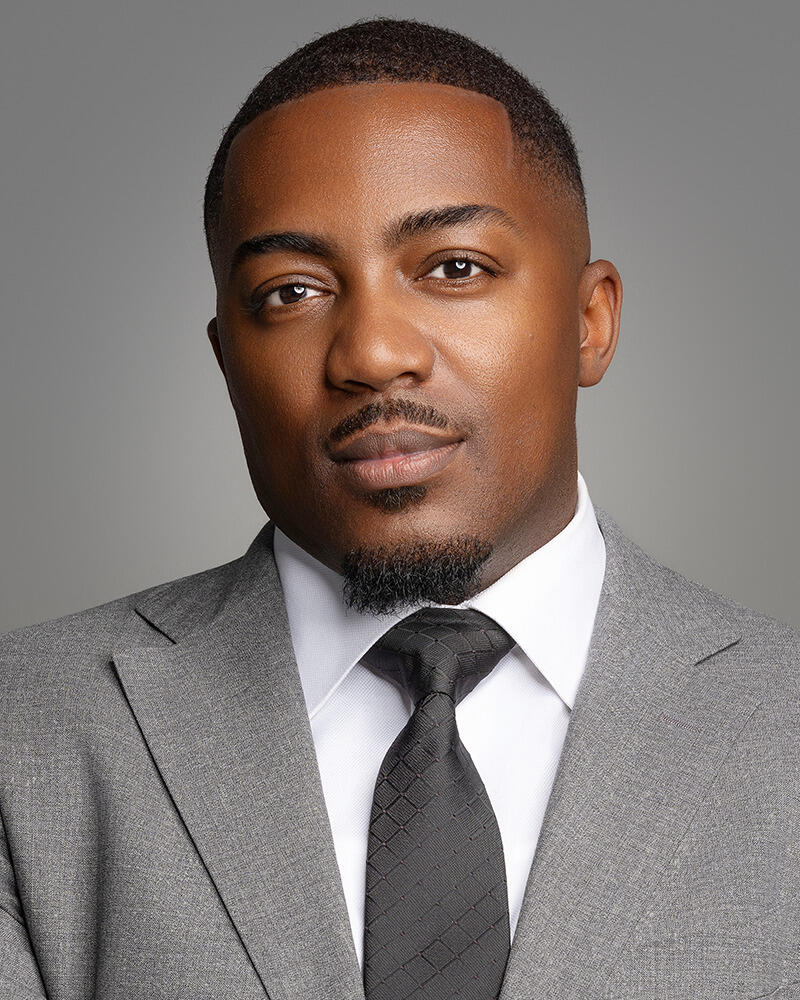 A photo of a man from the shoulders up. 