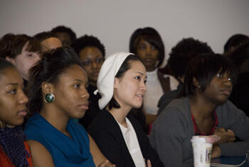 Associate Professor Linda Lee looks on as Momolu addresses the group.