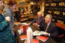 Pictured here are Trani (right) and Davis at a book signing on the evening of their lecture.